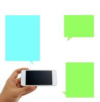 Person holding a phone with three colorful speech bubbles photo