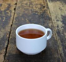 Cup of tea on wooden background photo