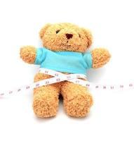 Teddy bear with measuring tape photo