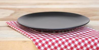 Plate and checkered tablecloth on table photo