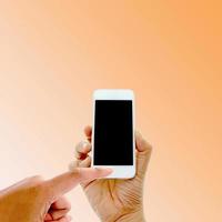 Person using a phone on an orange background photo