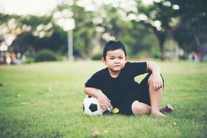 Little boy playing soccer football photo