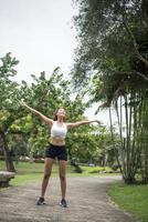 Young sporty woman stretching in the park photo