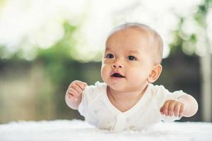 Newborn child relaxing on a rug photo