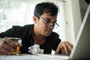 Young businessman frustrated at desk photo