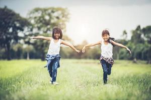 Two little girls having fun in the park photo