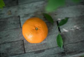 Orange on a wooden background photo