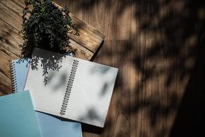 Top view of notebook on sunny desk photo