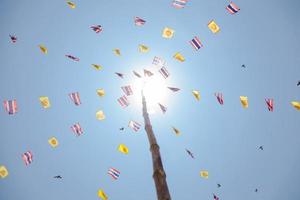 Flags on ropes connected to a pole photo