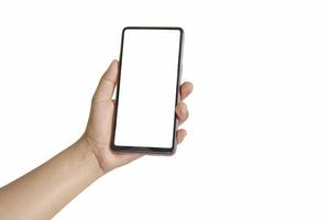 The hand is holding the white screen, the mobile phone is isolated on a white background photo