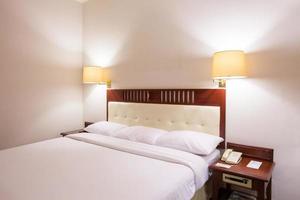 Standard white bedroom in hotel photo