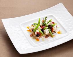 Aperitivo de queso fresco con verduras y frutas. foto