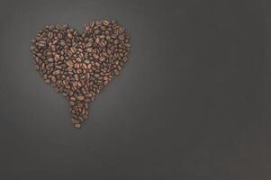 Coffee beans arranged in a heart shape photo