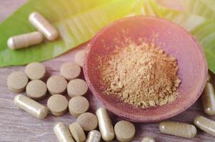 Herbal powder and medicine in wood bowl