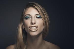 Beauty portrait of a young sexy woman against a dark blue background photo