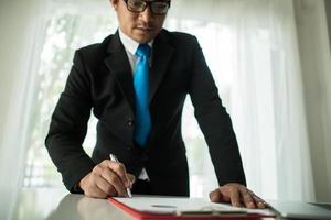 Young businessman working with laptop at office photo