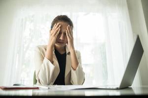 Young businessperson suffering from a headache photo