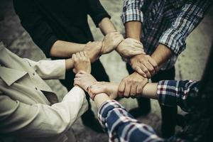 Business people with their arms embraced by one another photo