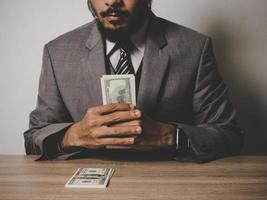 Happy businessman with dollar banknotes photo