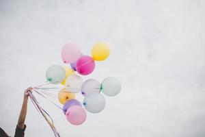 Woman with colorful balloons outside photo