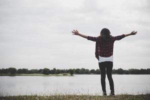 Young beautiful hipster woman in a field at sunset photo