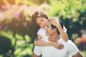 Happy couple on vacation enjoying each other in the park photo