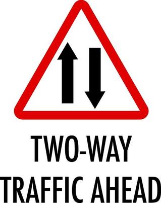 Two-way traffic ahead sign on white background