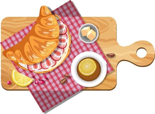 Top view of croissant sandwiches and tea cup on a cutting board