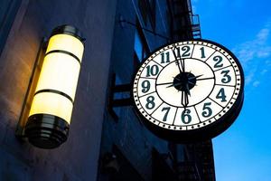 Vintage street clock on the building in New York City photo