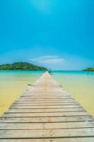 Wooden pier on tropical beach photo