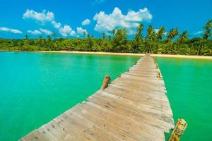 Wooden pier on tropical beach photo