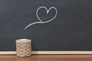 A kettle and a heart shape on a blackboard photo