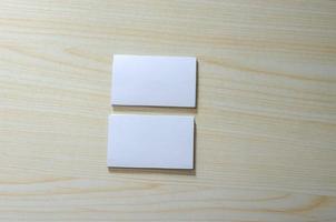 A blank paper mockup for business cards on a wooden table photo