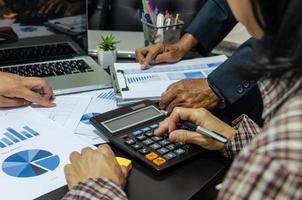 A business meeting to review documents and information on marketing and financial statements, reports, and business planning photo