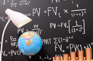 Coins in front of a blackboard photo