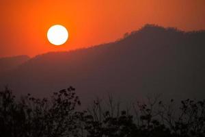 Orange sunset over mountains photo