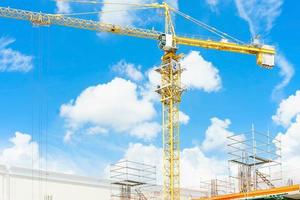 Construction cranes and high-rise building under construction photo