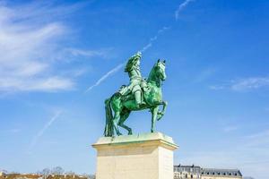 Statue on the Place d'Armes in front of the Royal Palace of Versailles in France photo