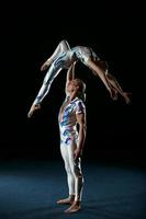 Man and woman gymnasts performing together