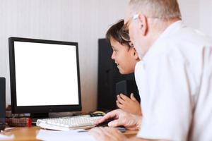 Grandfather and grandson using a computer mock-up photo