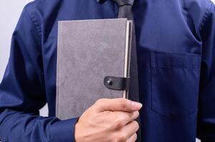 Man holding a notebook photo