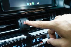 Closeup of a finger pressing emergency stop button in a car photo