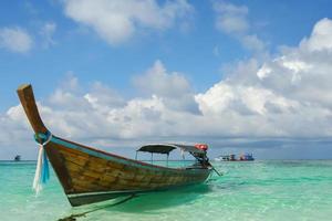 Long boat  floating on tropical beach