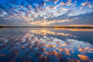 Sunset clouds reflected in water