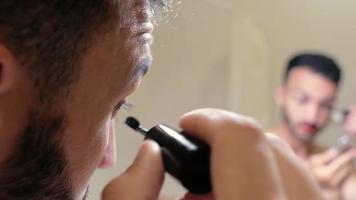 Man Applying Makeup in Front of a Mirror video