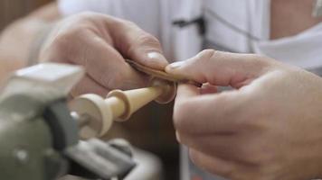 Carpenter Polishing a Wooden Part with Leather