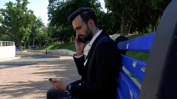 Man Using a Mobile Phone on A Bench video