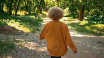 Unrecognizable blonde female strolls outdoors video