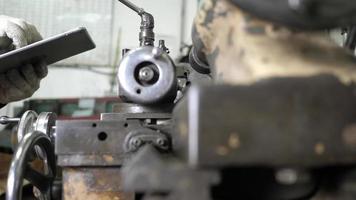 Engineer Using a Tablet for Checking a Lathe Machine video