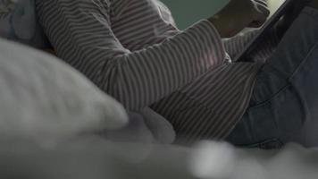 Relaxing Woman Using a Digital Tablet in Bed video